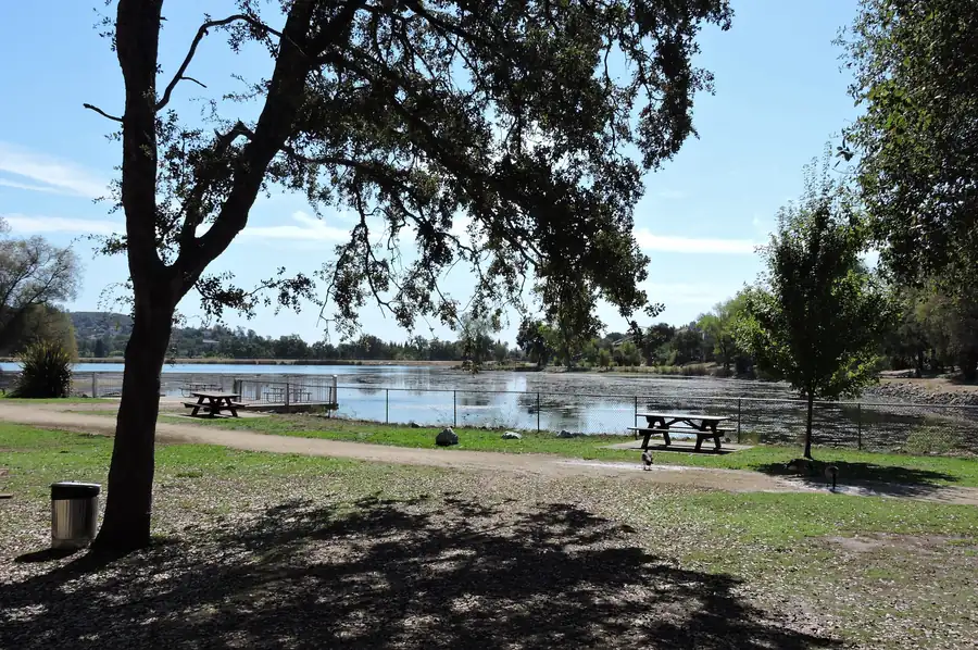 Cameron Park Lake with oaks and homes along the shoreline in El Dorado County